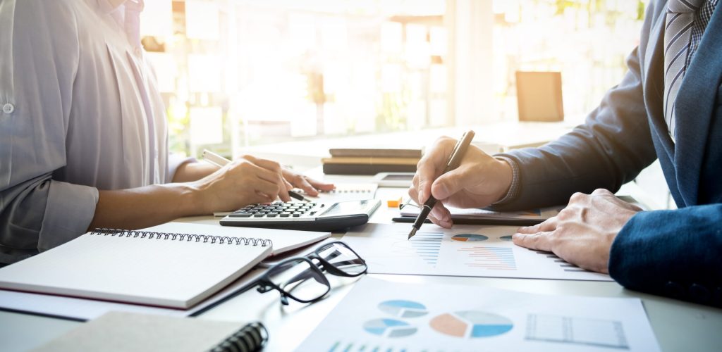 business man financial inspector and secretary making report, calculating or checking balance. Internal Revenue Service inspector checking document. Audit concept